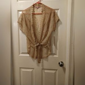 Almost famous lace top, perfect over a summer dress or tank top! Size medium tan